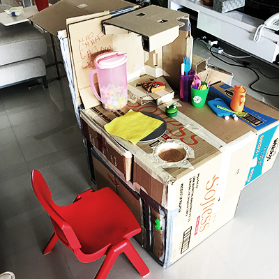 Children building cardboard stalls
